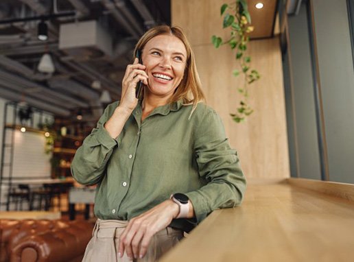Lady smiles while speaking on phone