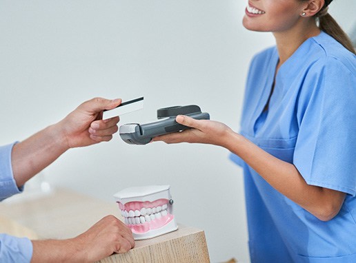 A man paying his dentist 