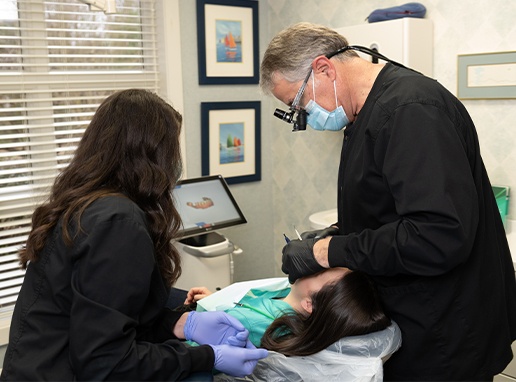 Dentist and team member performing periodontal exam