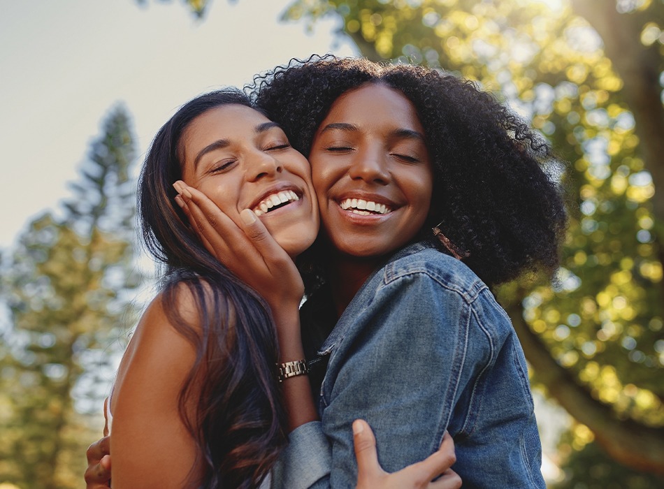 Two women with flawless smiles after cosmetic dentistry