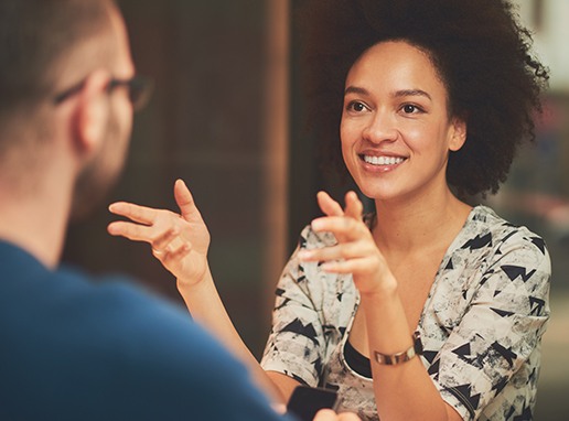 Woman discussing benefits of cosmetic dentistry with dentist