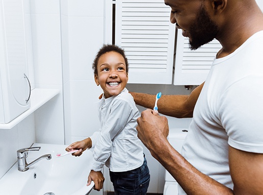 Father and child brushing teeth to prevent dental emergencies