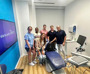 Dental team members behind reception desk