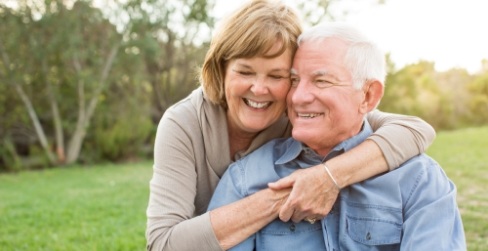 older man and woman hugging