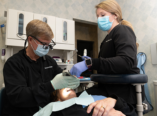 Doctor Schrimper and team member treating dental patient