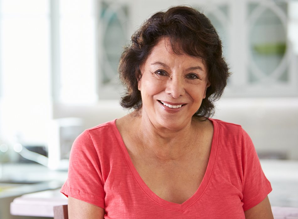 Woman sharing smile after replacing missing teeth