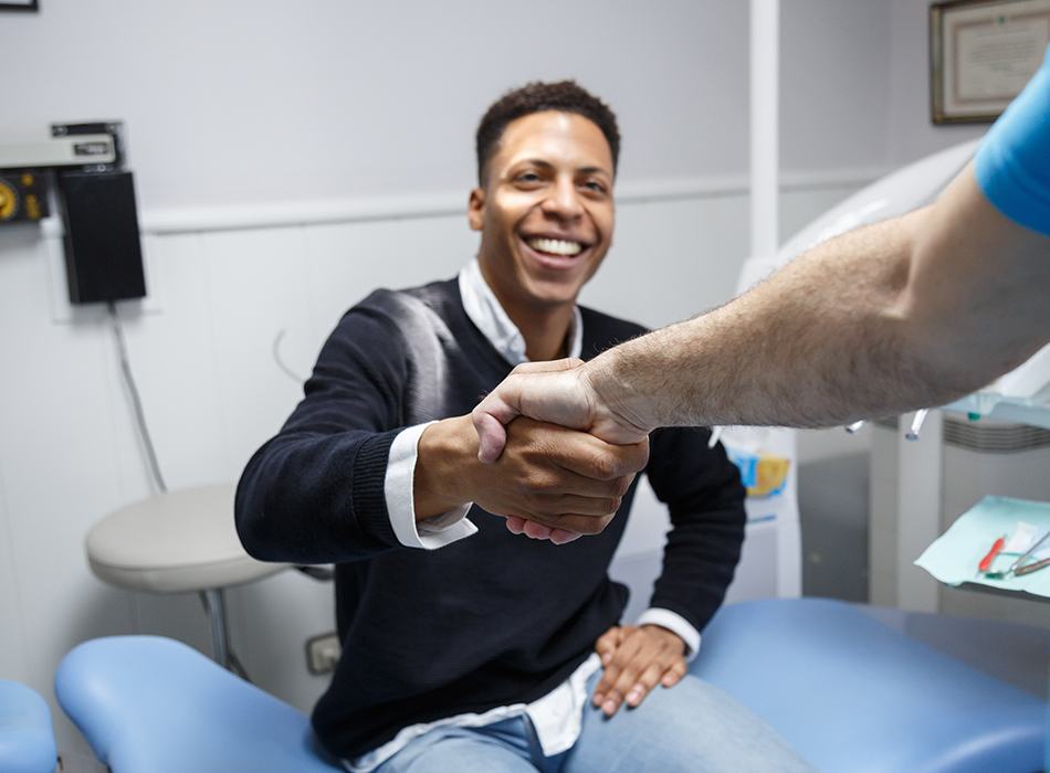 Man shaking hands with dentist during preventive dentistry visit