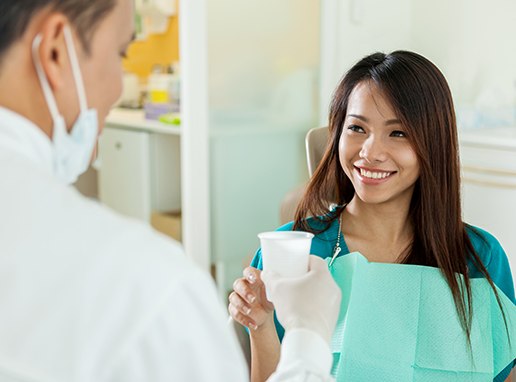 Woman using oral rinse after root canal therapy