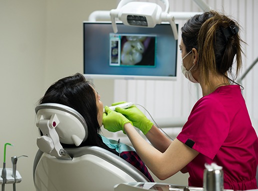 Dental team member using intraoral camera to capture images