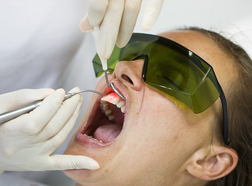 Patient receiving soft tissue laser dentistry