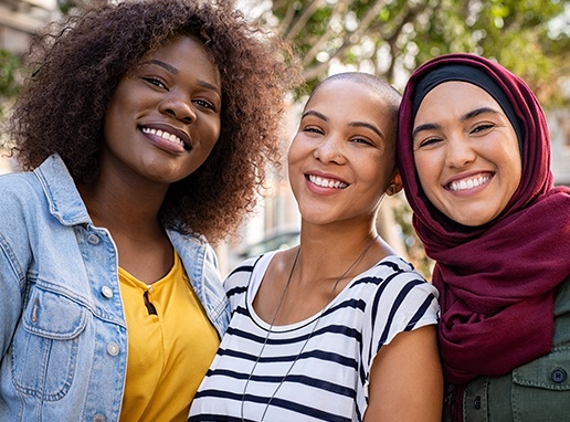 Three women with brilliant smiles after teeth whitening