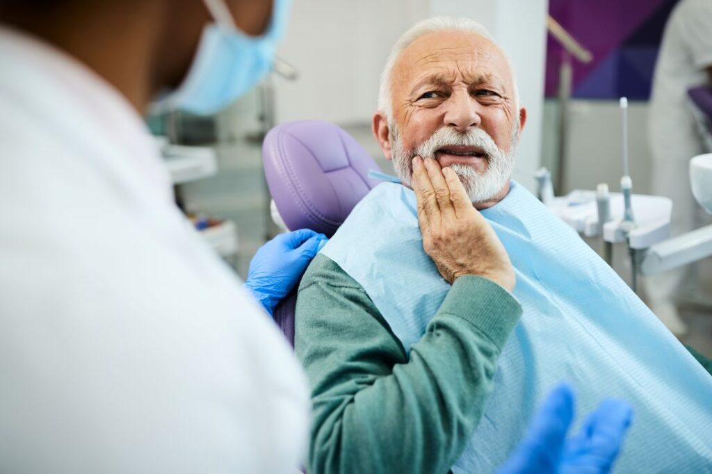 A man in a dental chair with oral pain